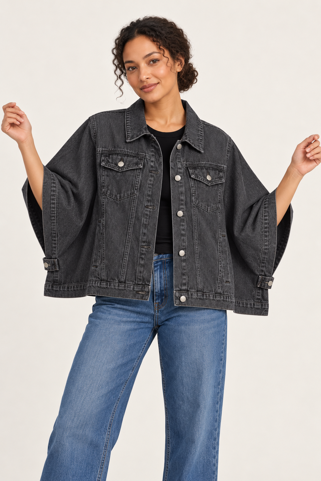 Woman wearing an oversized denim cape jacket in Smoked Graphite, front view #413E41