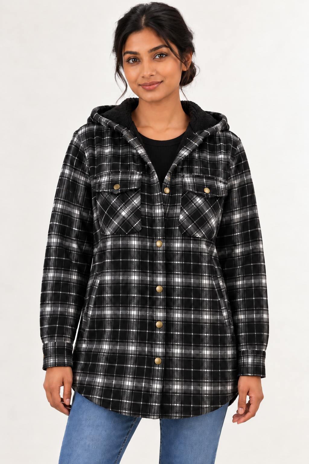 Front view of a model wearing the LOHNR Alder Hooded Shacket in Black, with fine gray and off-white plaid, black hood lining, flap chest pockets and rounded hem. #222121