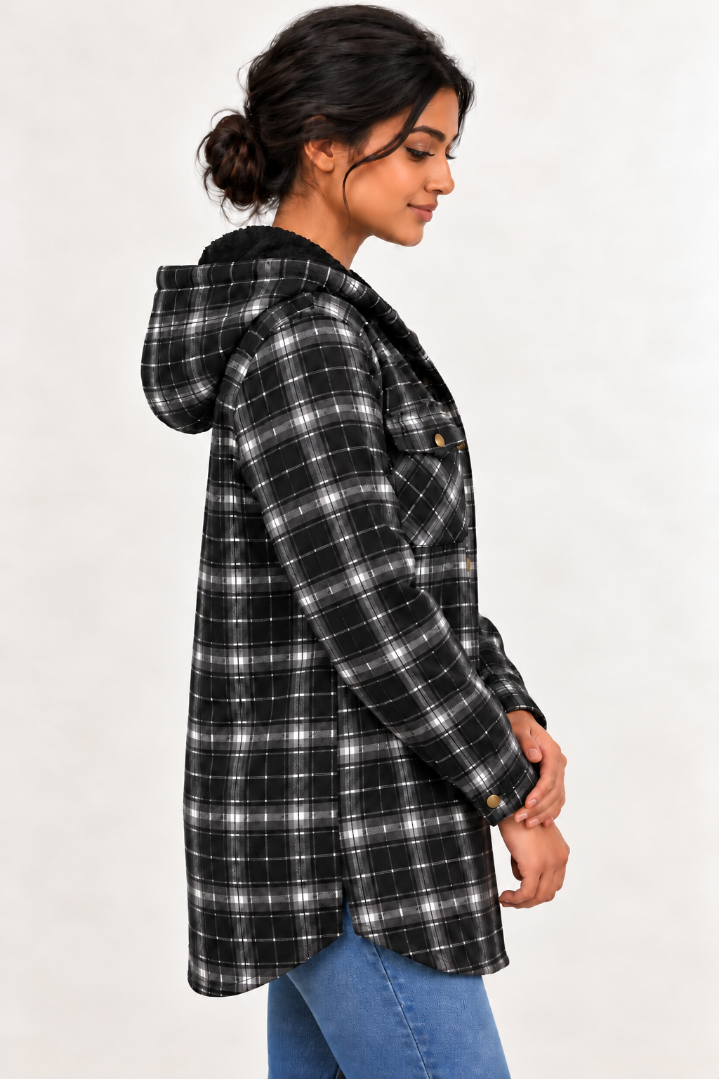 Side view of a model wearing the LOHNR Alder Hooded Shacket in Black, showing fine plaid, a hood, snap cuff and curved hem.