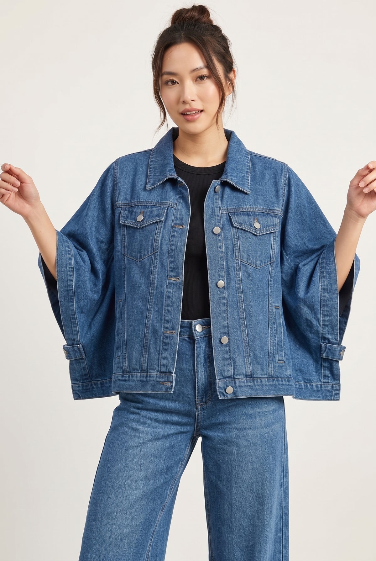 Woman wearing an oversized denim cape jacket in Heritage Blue, front view #567393