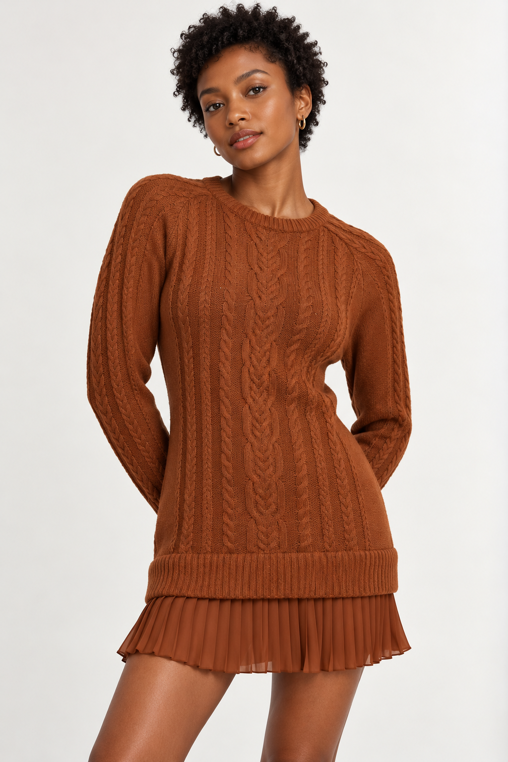 Woman wearing a cable-knit mini dress with a pleated hem in Burnished Cinnamon, front view #8C4120