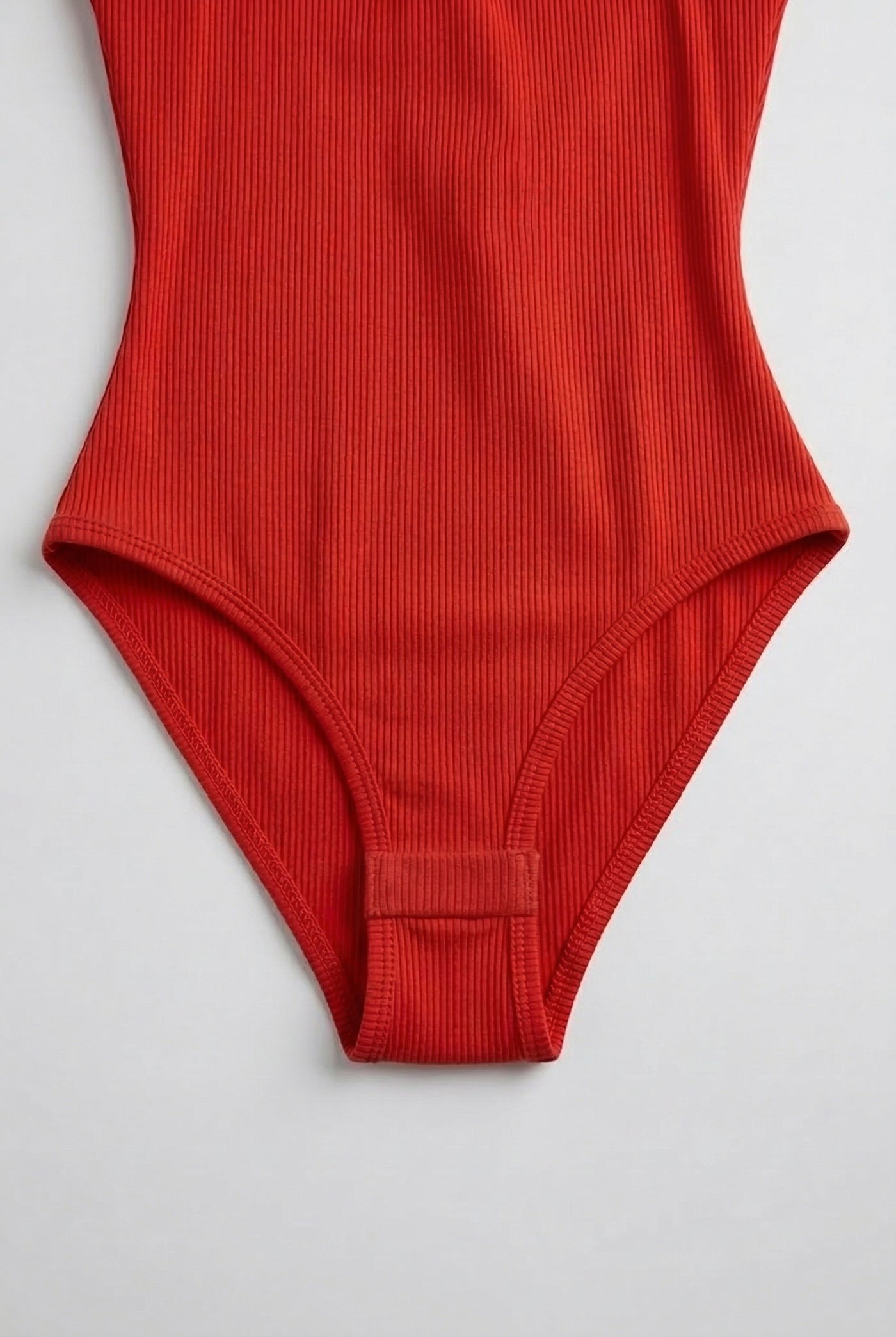 Model wearing a Cayenne red square neck one-piece swimsuit