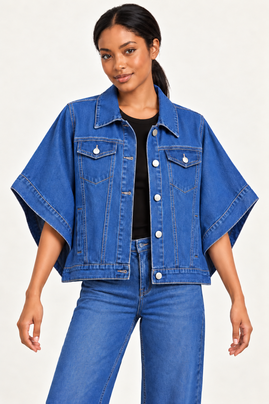 Woman wearing an oversized denim cape jacket in Riviera Blue, front view #3867B3