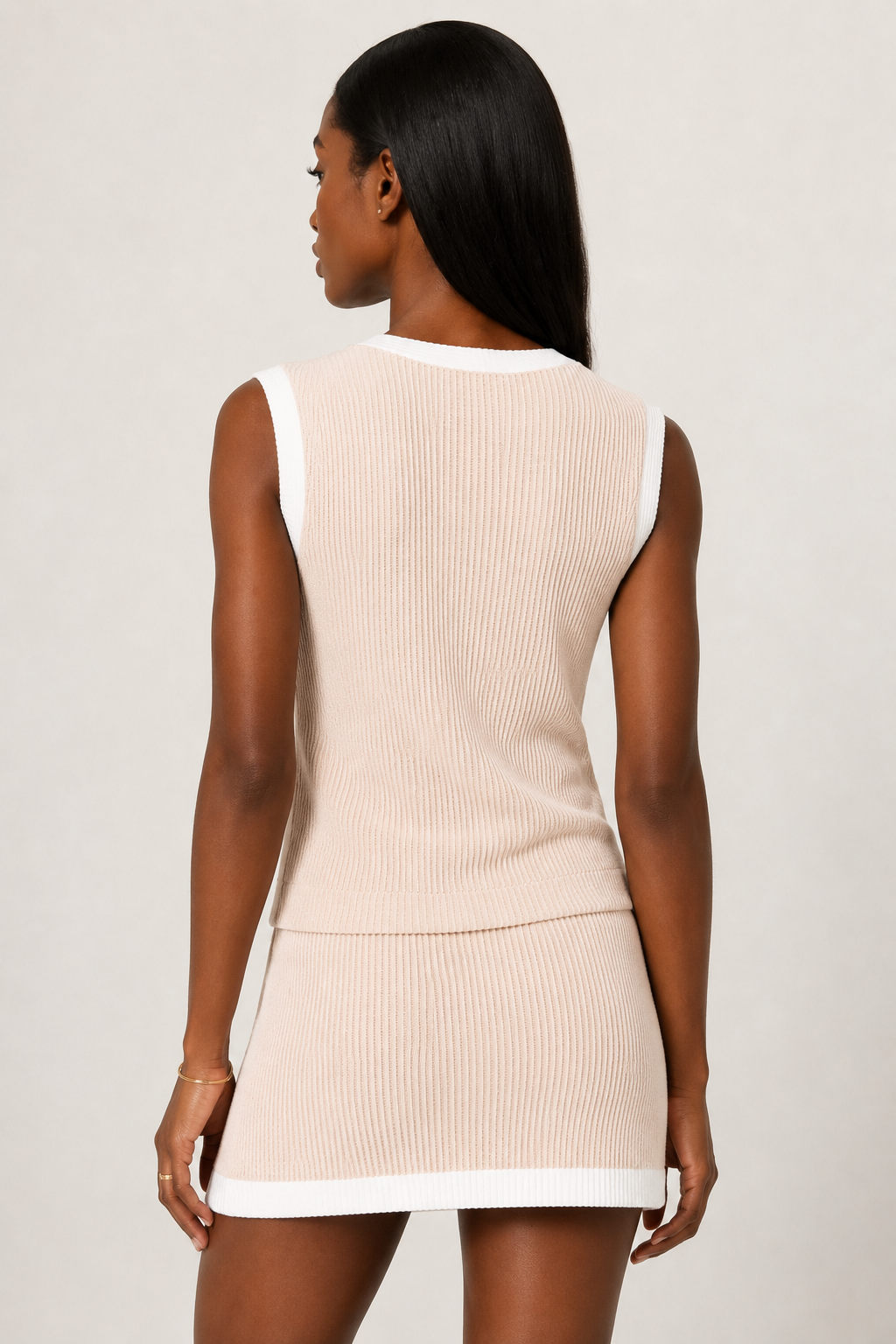 LOHNR Bound Rib Set in Dune. A structured light blue sleeveless knit top and matching asymmetric skirt, finished with precision contrast white binding.
