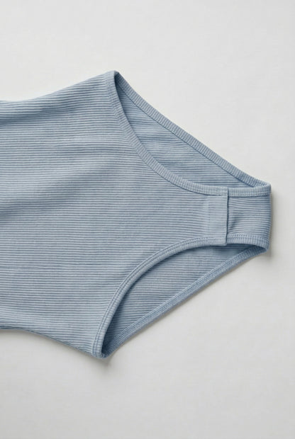 Model wearing an Echo Blue light blue square neck one-piece swimsuit