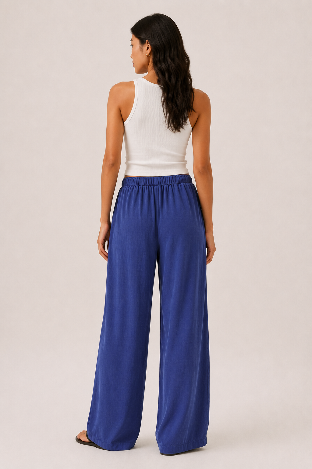 Woman modeling premium high-waisted wide-leg pants in bright blue Cobalt against a clean studio background