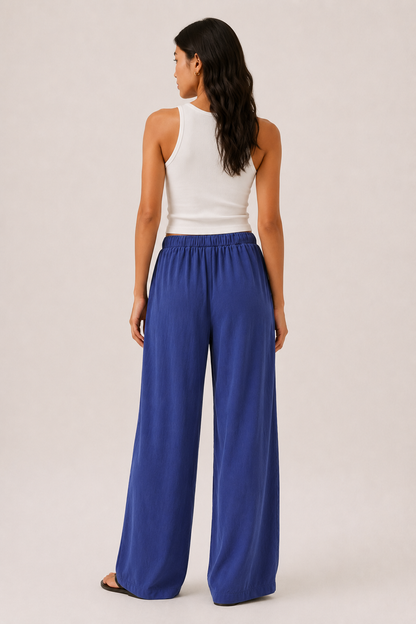 Woman modeling premium high-waisted wide-leg pants in bright blue Cobalt against a clean studio background
