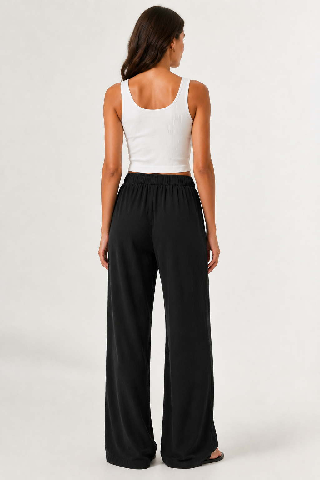 Woman modeling premium high-waisted wide-leg pants in black Onyx against a clean studio background