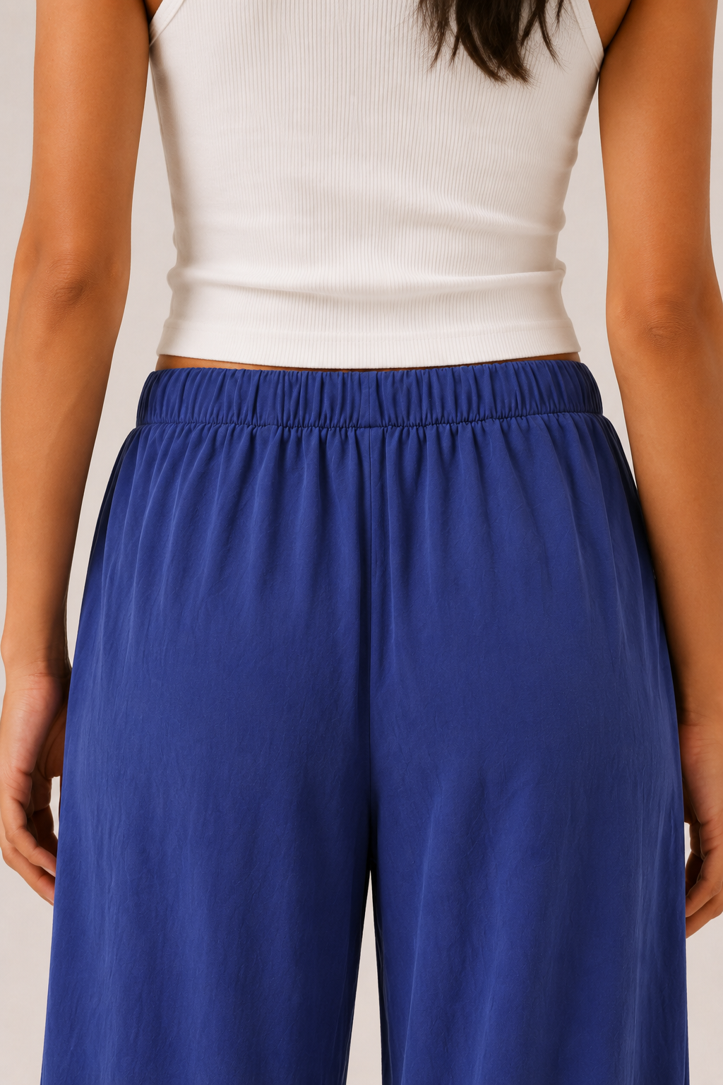 Woman modeling premium high-waisted wide-leg pants in bright blue Cobalt against a clean studio background