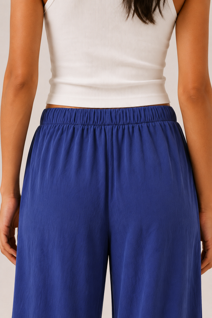 Woman modeling premium high-waisted wide-leg pants in bright blue Cobalt against a clean studio background