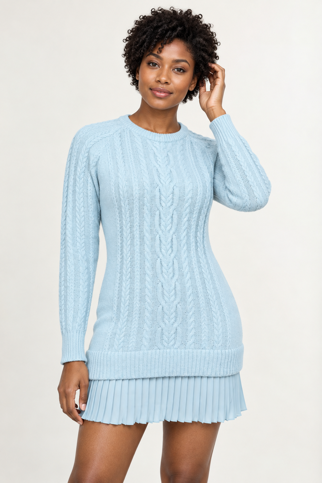 Woman wearing a cable-knit mini dress with a pleated hem in Glacial Blue, front view #C5DFEC