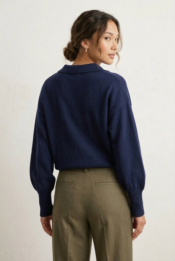Woman wearing the LOHNR Amélie Collared Sweater in deep indigo, featuring a relaxed V-neck and structured polo collar.