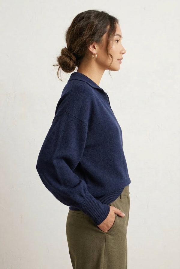 Woman wearing the LOHNR Amélie Collared Sweater in deep indigo, featuring a relaxed V-neck and structured polo collar.