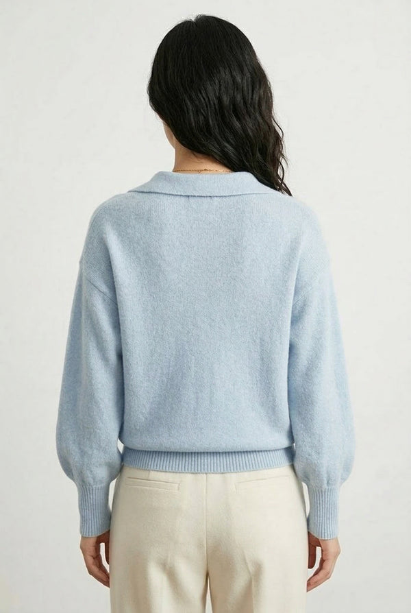 Woman wearing the LOHNR Amélie Collared Sweater in iced aqua, featuring a relaxed V-neck and structured polo collar.