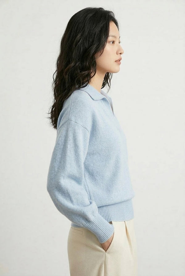 Woman wearing the LOHNR Amélie Collared Sweater in iced aqua, featuring a relaxed V-neck and structured polo collar.