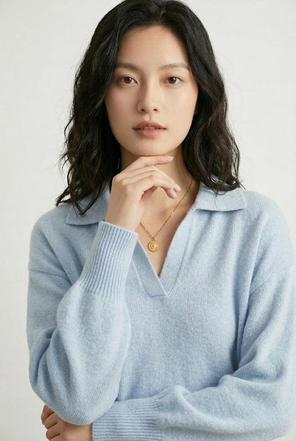 Woman wearing the LOHNR Amélie Collared Sweater in iced aqua, featuring a relaxed V-neck and structured polo collar.