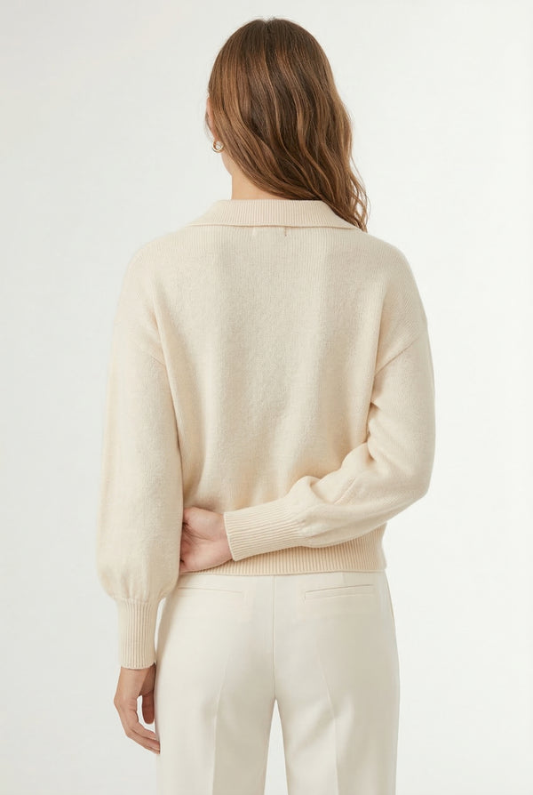 Woman wearing the LOHNR Amélie Collared Sweater in light birch, featuring a relaxed V-neck and structured polo collar.