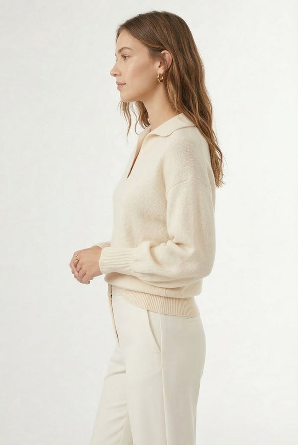 Woman wearing the LOHNR Amélie Collared Sweater in light birch, featuring a relaxed V-neck and structured polo collar.