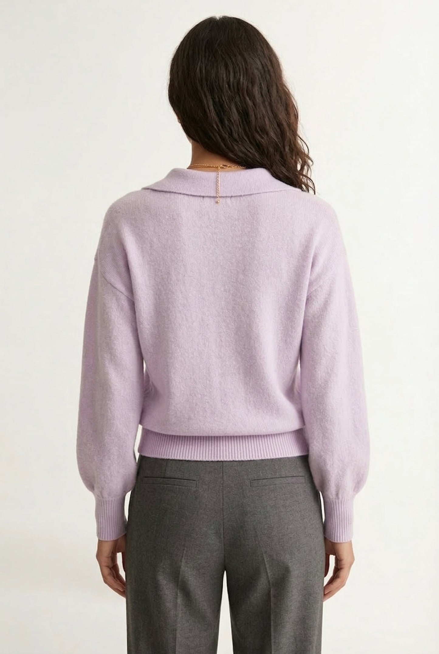 Woman wearing the LOHNR Amélie Collared Sweater in soft lavandin, featuring a relaxed V-neck and structured polo collar.
