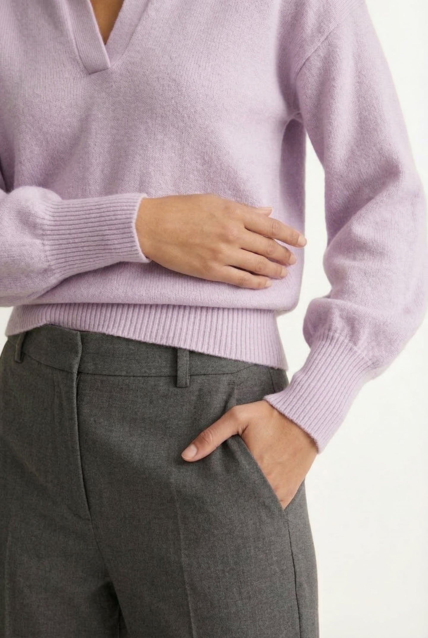 Woman wearing the LOHNR Amélie Collared Sweater in soft lavandin, featuring a relaxed V-neck and structured polo collar.