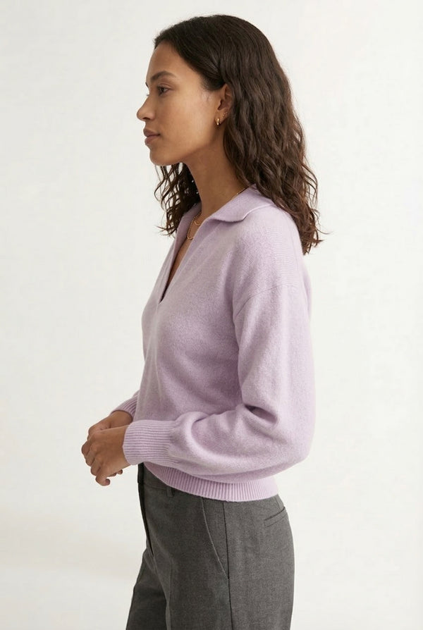 Woman wearing the LOHNR Amélie Collared Sweater in soft lavandin, featuring a relaxed V-neck and structured polo collar.