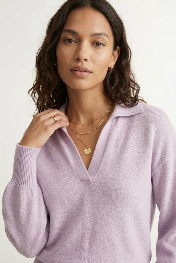 Woman wearing the LOHNR Amélie Collared Sweater in soft lavandin, featuring a relaxed V-neck and structured polo collar.