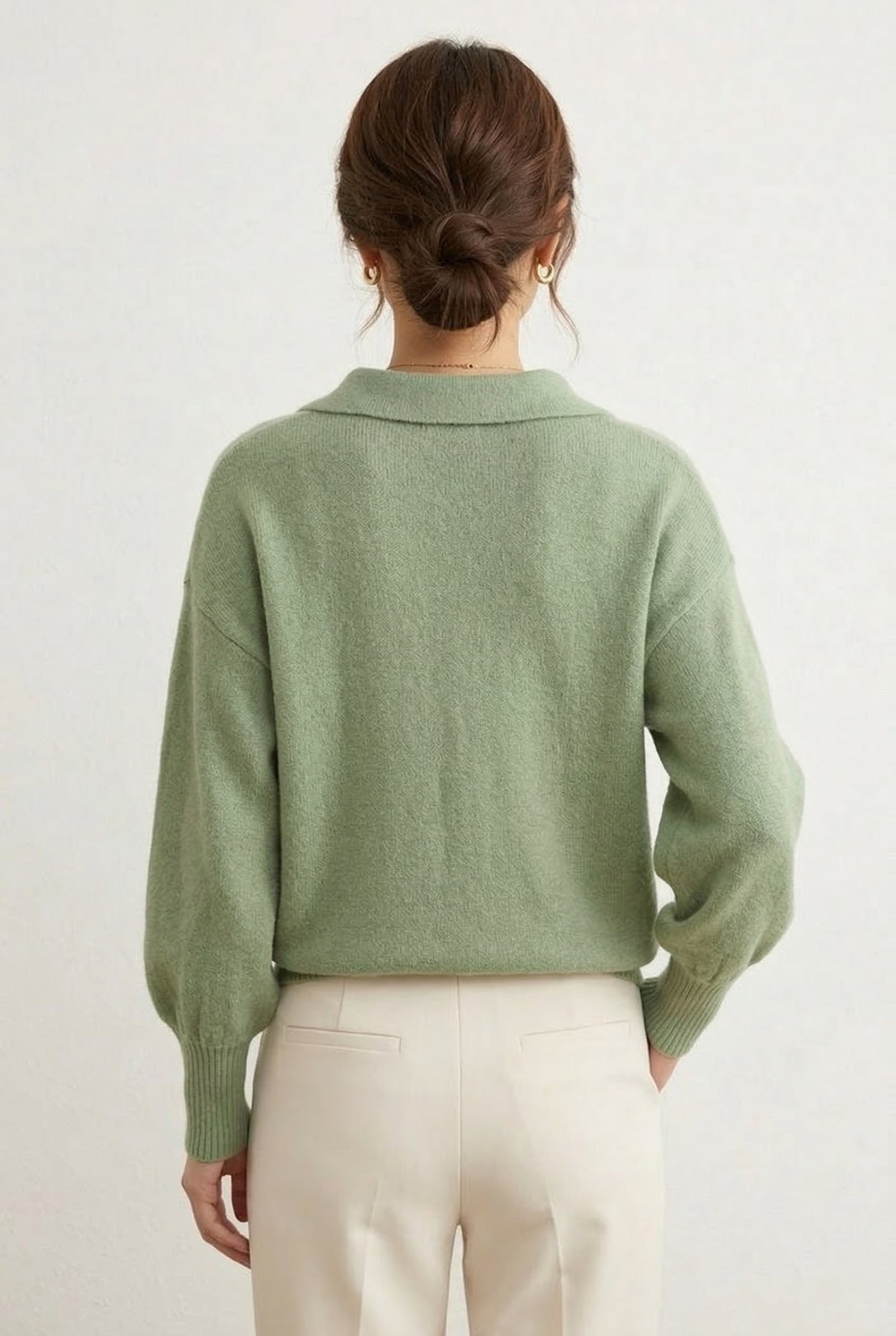 Woman wearing the LOHNR Amélie Collared Sweater in whisper mint, featuring a relaxed V-neck and structured polo collar.