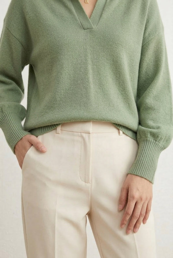 Woman wearing the LOHNR Amélie Collared Sweater in whisper mint, featuring a relaxed V-neck and structured polo collar.