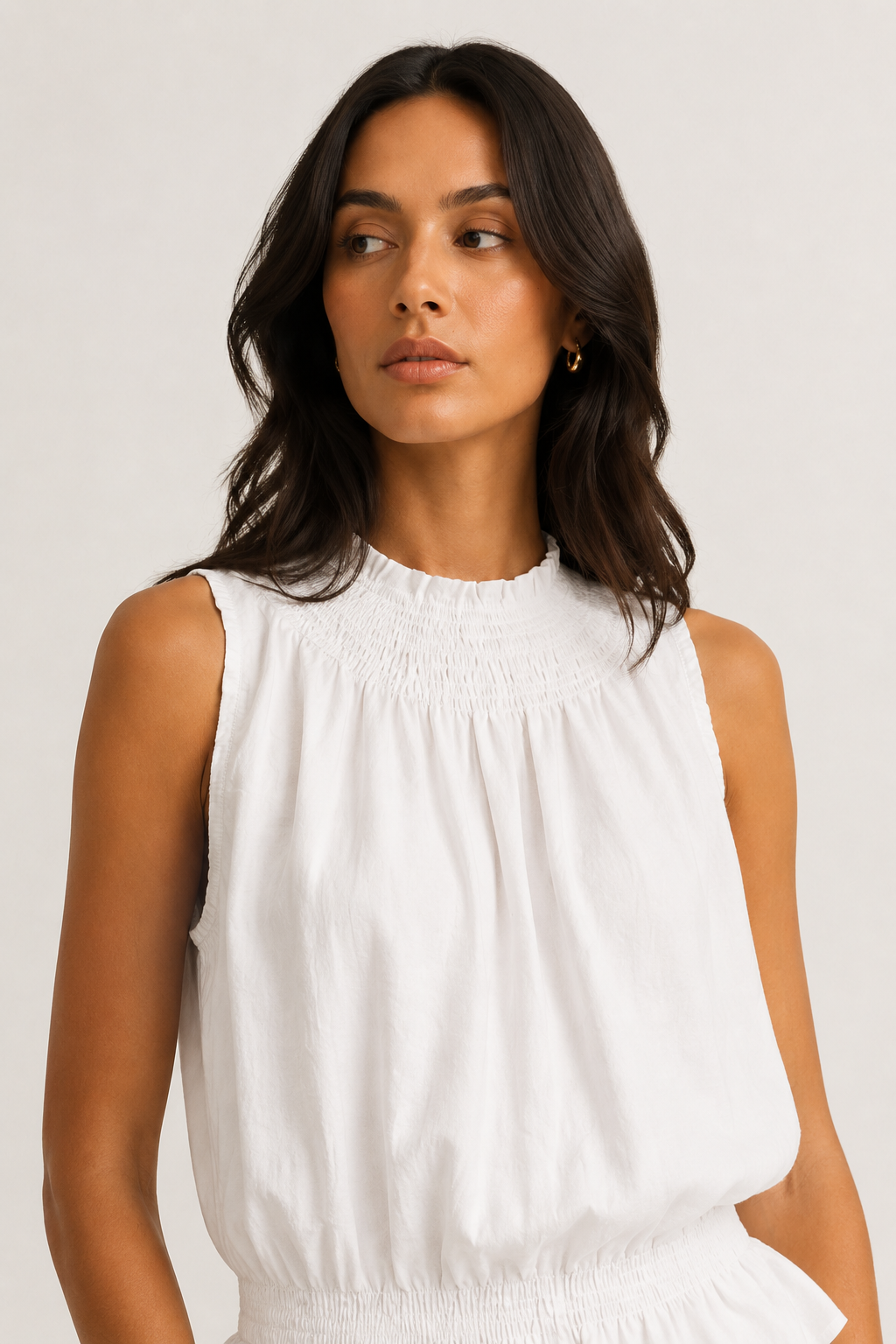 Woman wearing a premium minimalist blanc white two piece set with sleeveless top and wide leg pants