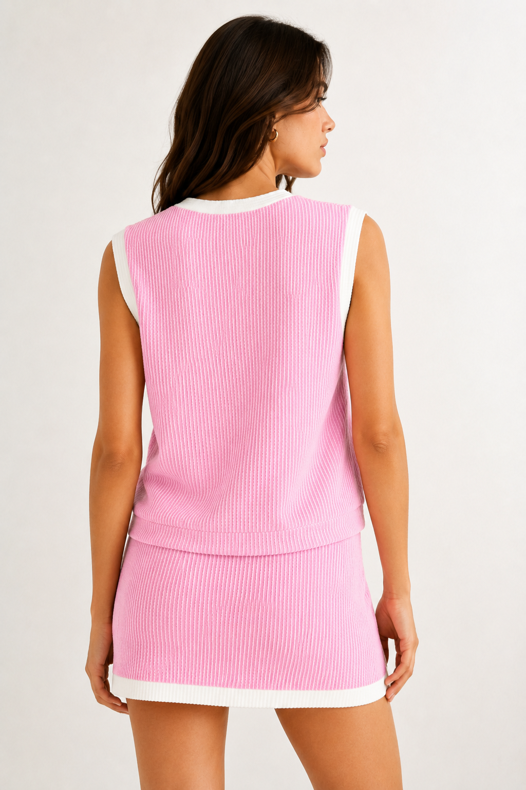 LOHNR Bound Rib Set in Sorbet. A structured soft pink sleeveless knit top and matching asymmetric skirt, finished with precision contrast white binding.