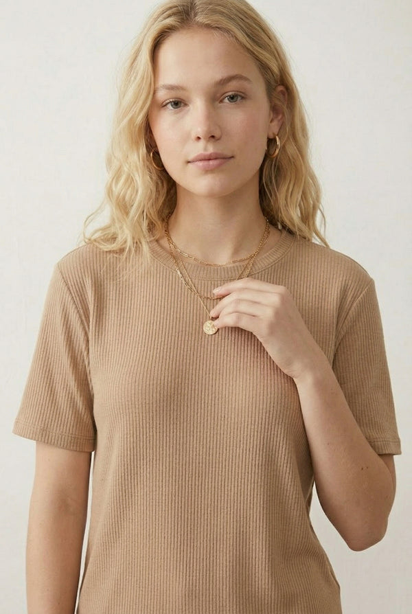 Woman modeling the LOHNR Celine Rib Set in Dune, an elevated ribbed t-shirt and short loungewear set