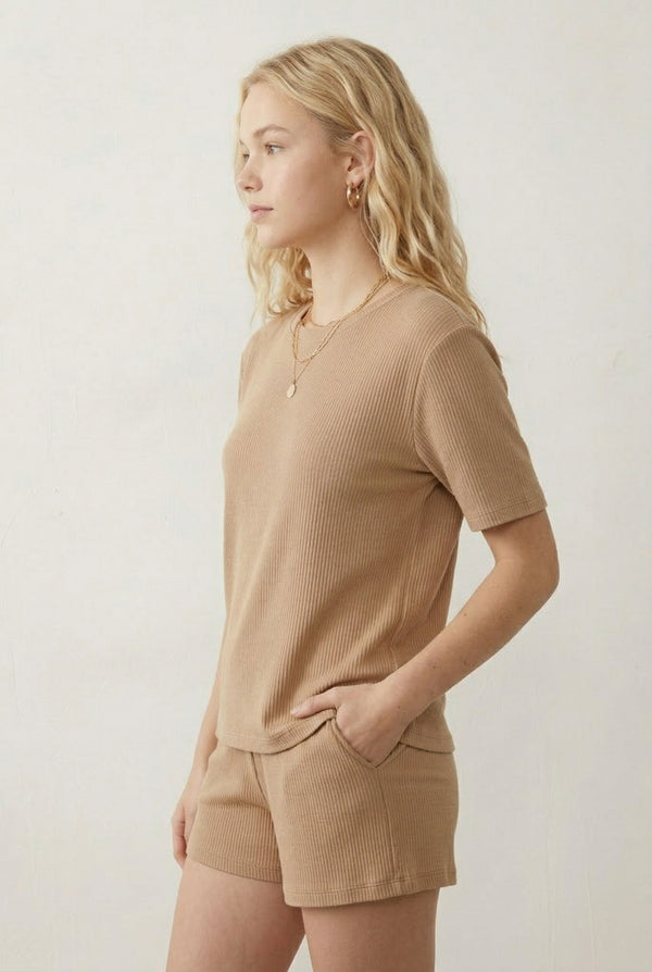 Woman modeling the LOHNR Celine Rib Set in Dune, an elevated ribbed t-shirt and short loungewear set