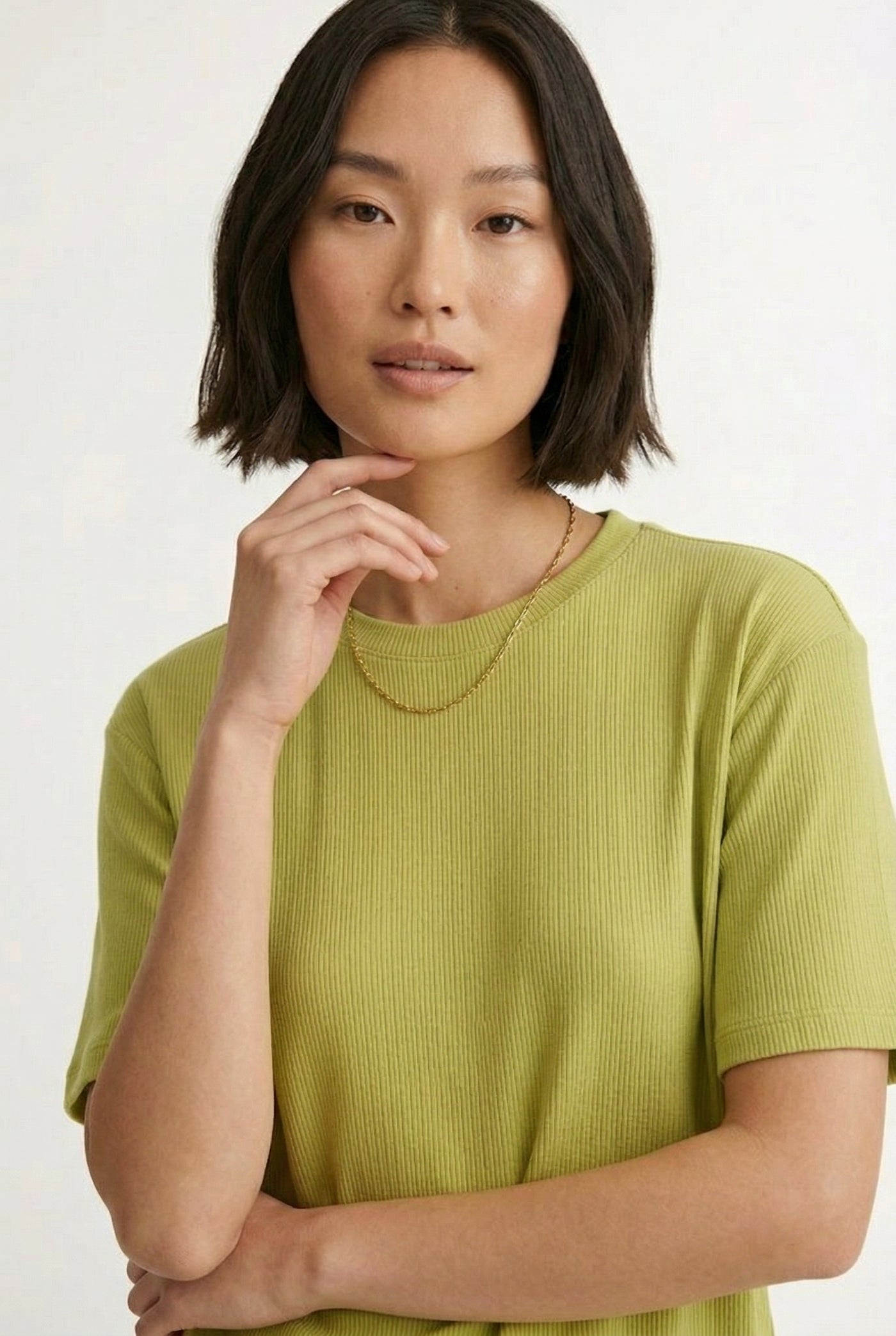 Woman modeling the LOHNR Celine Rib Set in Lemongrass, an elevated ribbed t-shirt and short loungewear set
