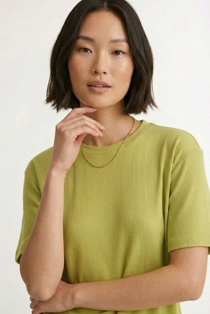Woman modeling the LOHNR Celine Rib Set in Lemongrass, an elevated ribbed t-shirt and short loungewear set