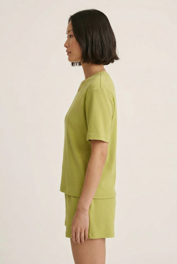 Woman modeling the LOHNR Celine Rib Set in Lemongrass, an elevated ribbed t-shirt and short loungewear set
