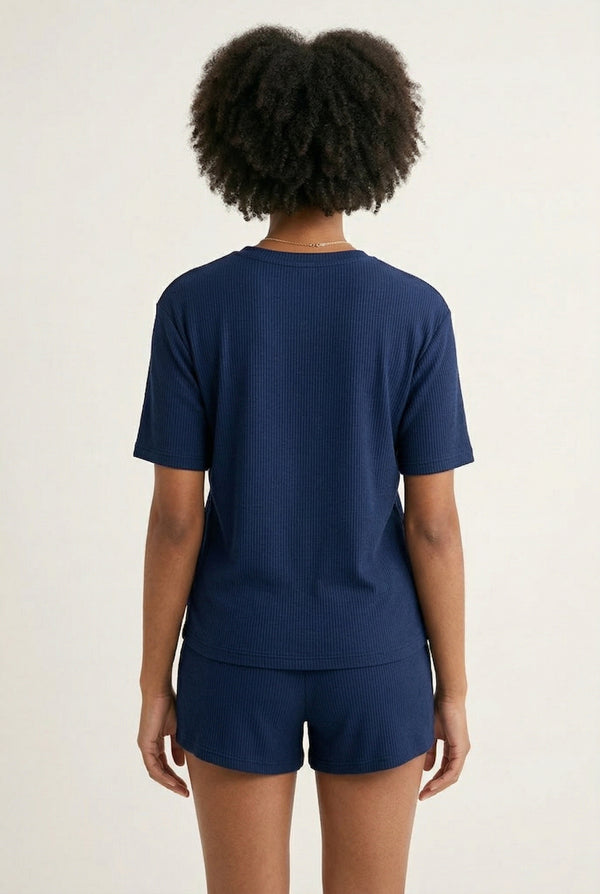 Woman modeling the LOHNR Celine Rib Set in Midnight, an elevated ribbed t-shirt and short loungewear set