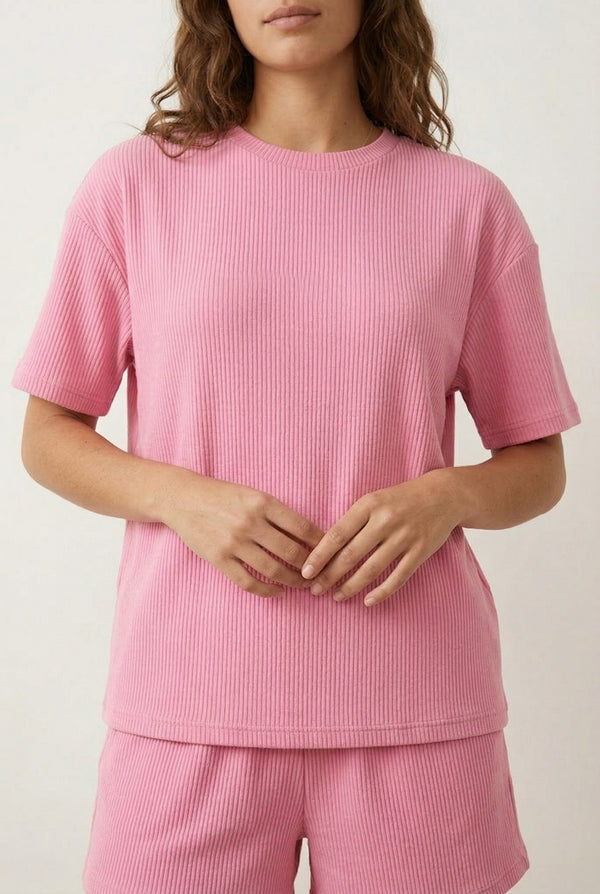 Woman modeling the LOHNR Celine Rib Set in Peony, an elevated ribbed t-shirt and short loungewear set