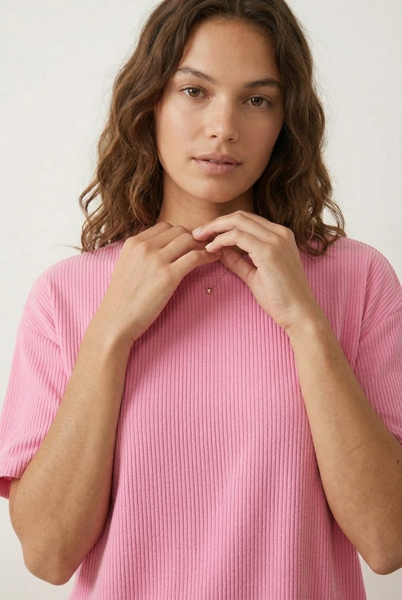 Woman modeling the LOHNR Celine Rib Set in Peony, an elevated ribbed t-shirt and short loungewear set