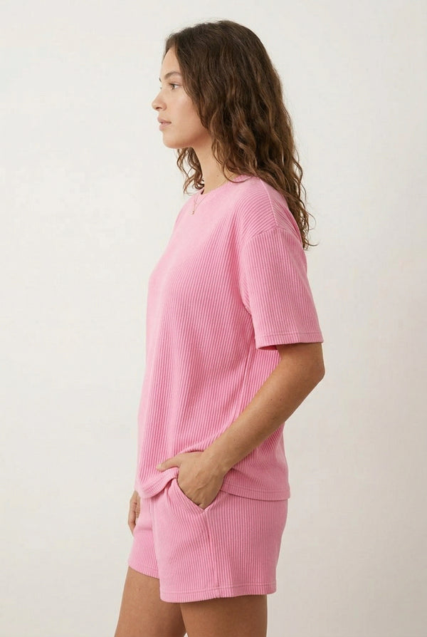 Woman modeling the LOHNR Celine Rib Set in Peony, an elevated ribbed t-shirt and short loungewear set