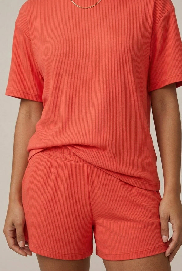 Woman modeling the LOHNR Celine Rib Set in Poppy, an elevated ribbed t-shirt and short loungewear set