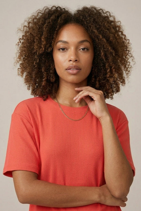 Woman modeling the LOHNR Celine Rib Set in Poppy, an elevated ribbed t-shirt and short loungewear set