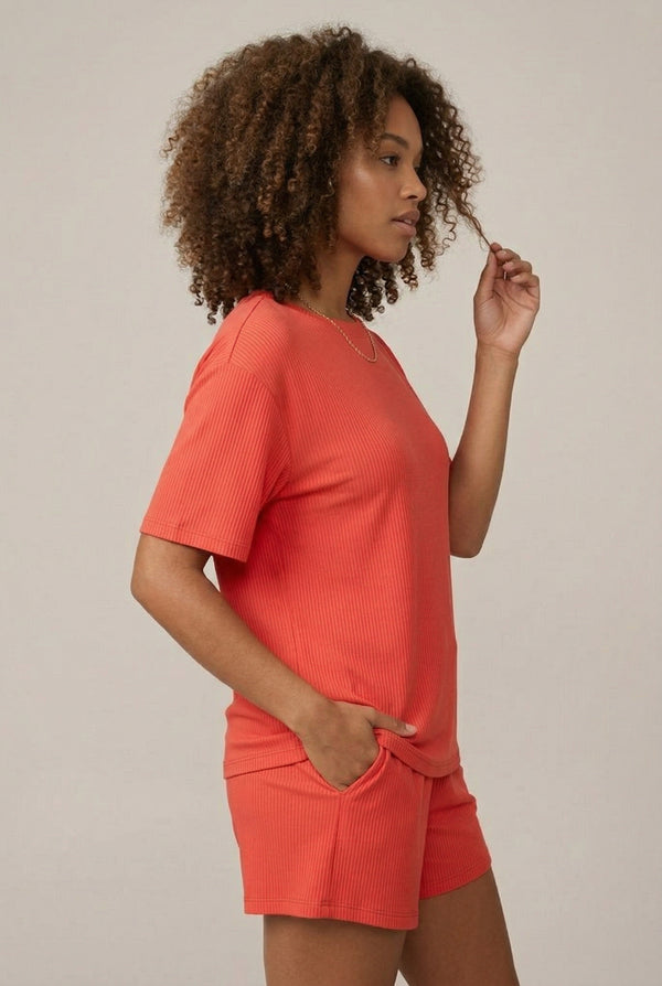 Woman modeling the LOHNR Celine Rib Set in Poppy, an elevated ribbed t-shirt and short loungewear set