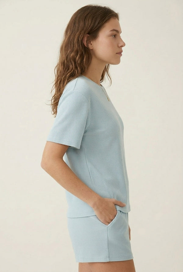 Woman modeling the LOHNR Celine Rib Set in Powder Blue, an elevated ribbed t-shirt and short loungewear set