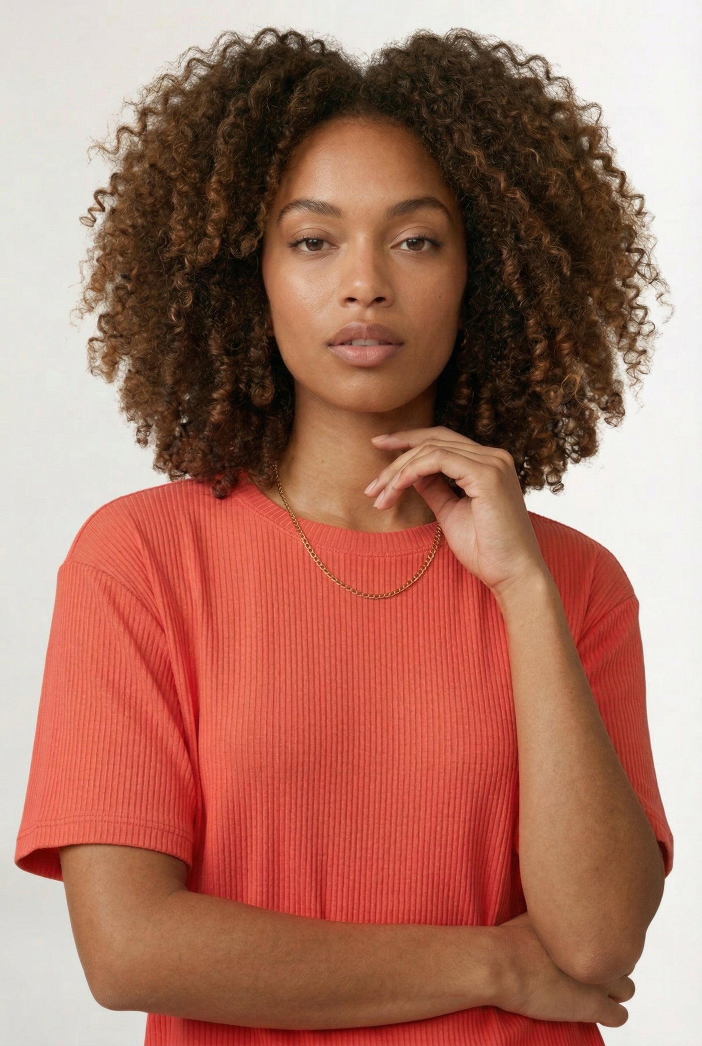 Woman modeling the LOHNR Celine Rib Set in Poppy, an elevated ribbed t-shirt and short loungewear set