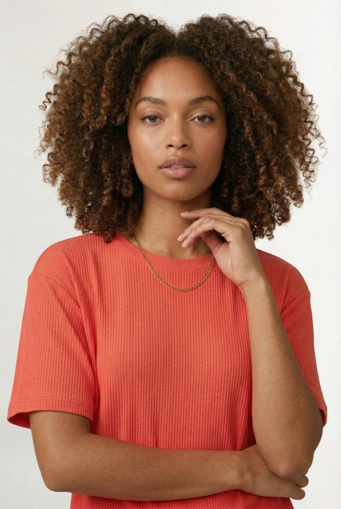 Woman modeling the LOHNR Celine Rib Set in Poppy, an elevated ribbed t-shirt and short loungewear set