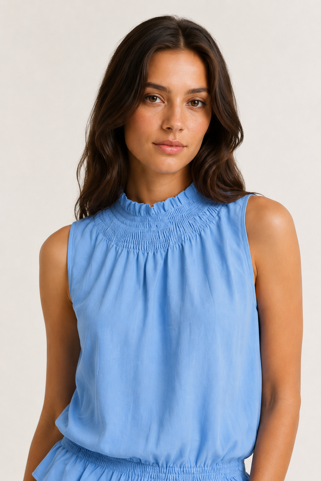 Woman wearing a premium minimalist chambray blue two piece set with sleeveless top and wide leg pants