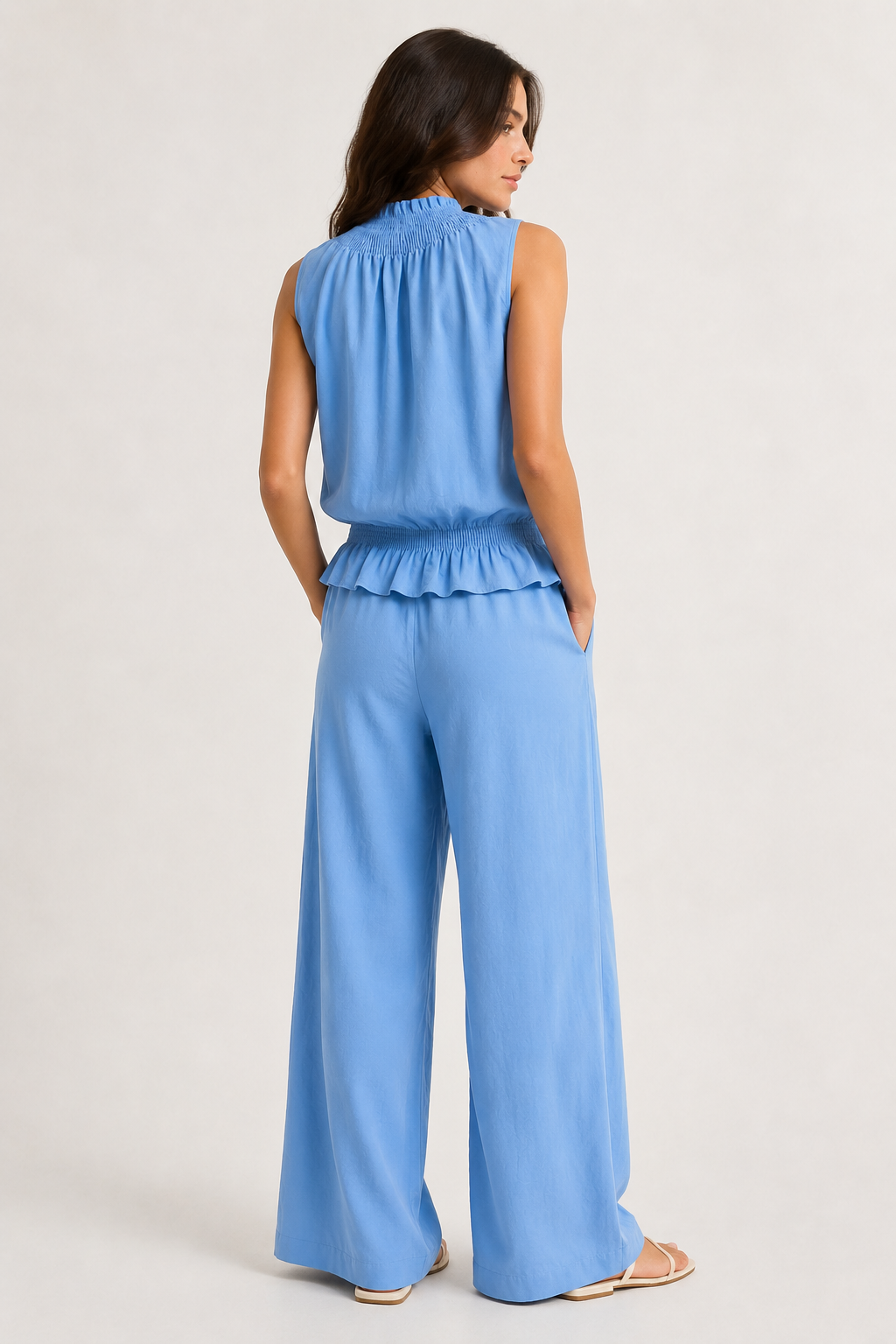 Woman wearing a premium minimalist chambray blue two piece set with sleeveless top and wide leg pants