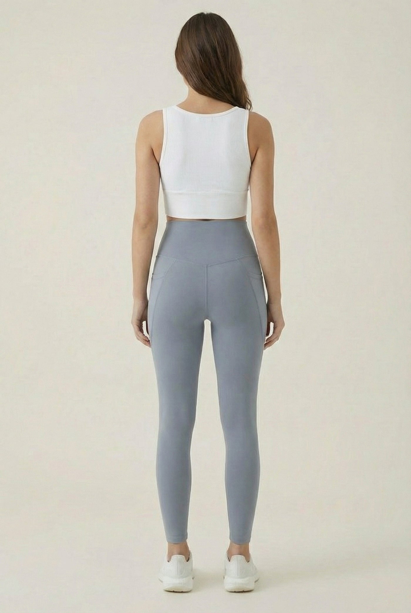 Women's high-waisted Contour Pocket Legging in Chambray blue, featuring a seamless front, hidden side pockets, and body-contouring compression fit.