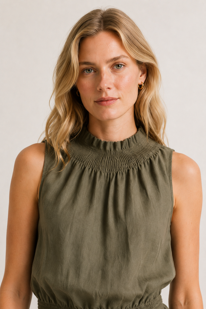 Woman wearing a premium minimalist cypress green two piece set with sleeveless top and wide leg pants