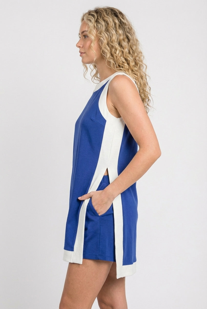 Model wearing the Lohnr Game Day Set in Blue, a 100% cotton two-piece outfit featuring hidden shorts with pockets.